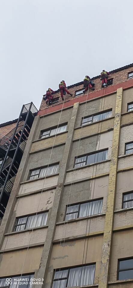 HRT technicians rappelling from rooftop
